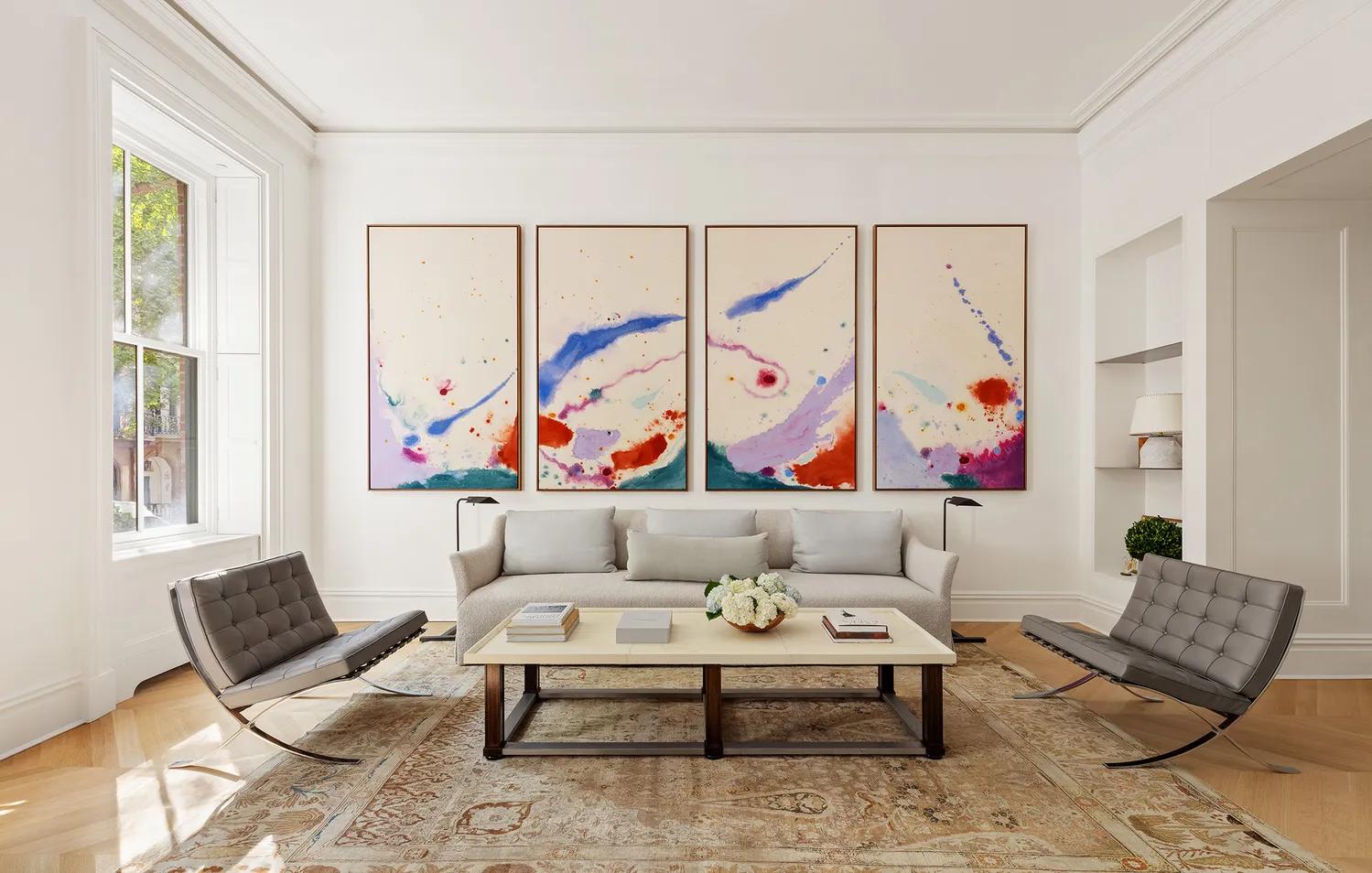 a living room with furniture and painting on the wall