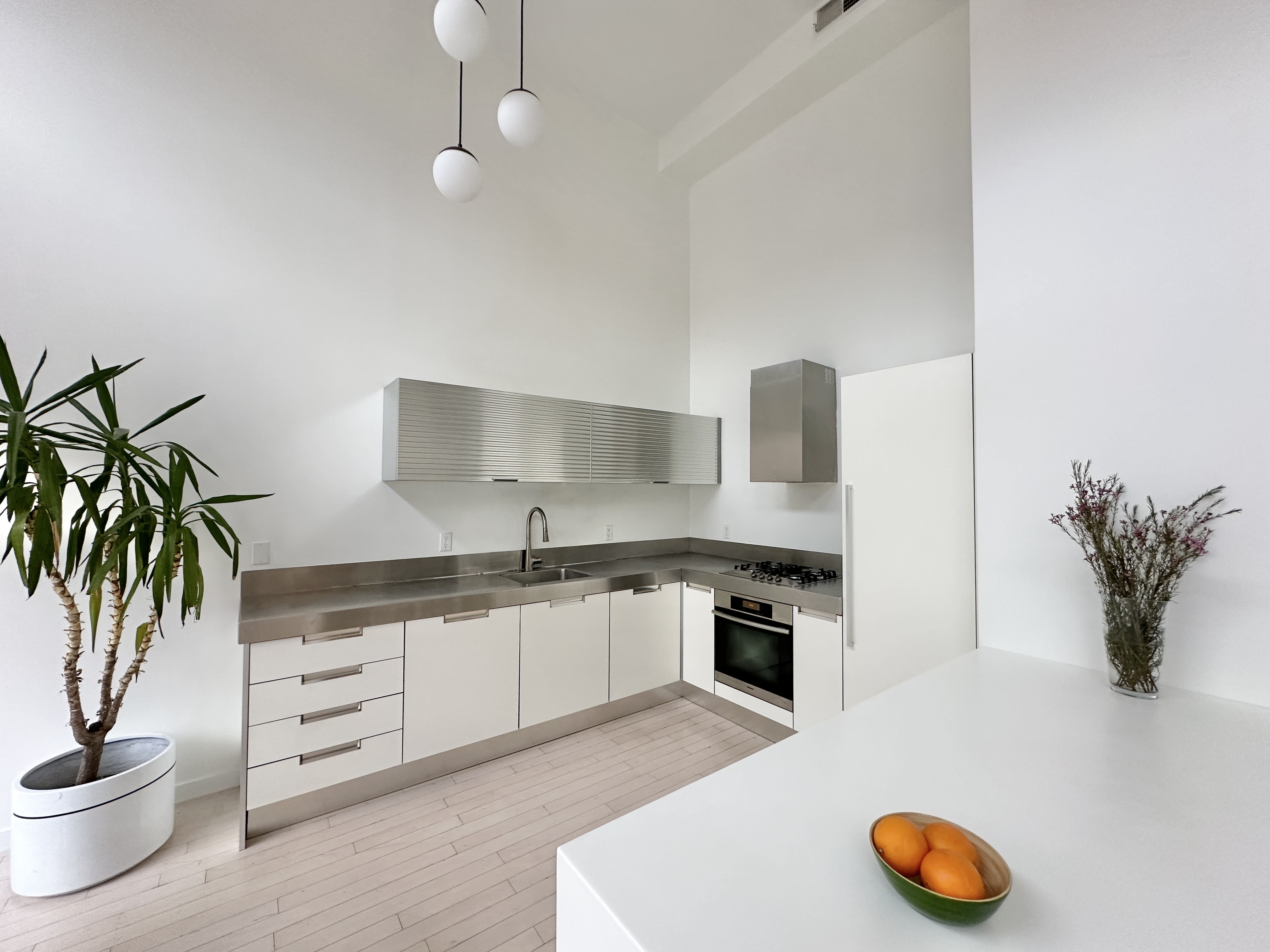 100 North 3rd Street, Unit 3E Brooklyn, NY 11249 - Photo 6 of 15 a kitchen with stainless steel appliances granite countertop a stove a sink and a white wooden cabinets