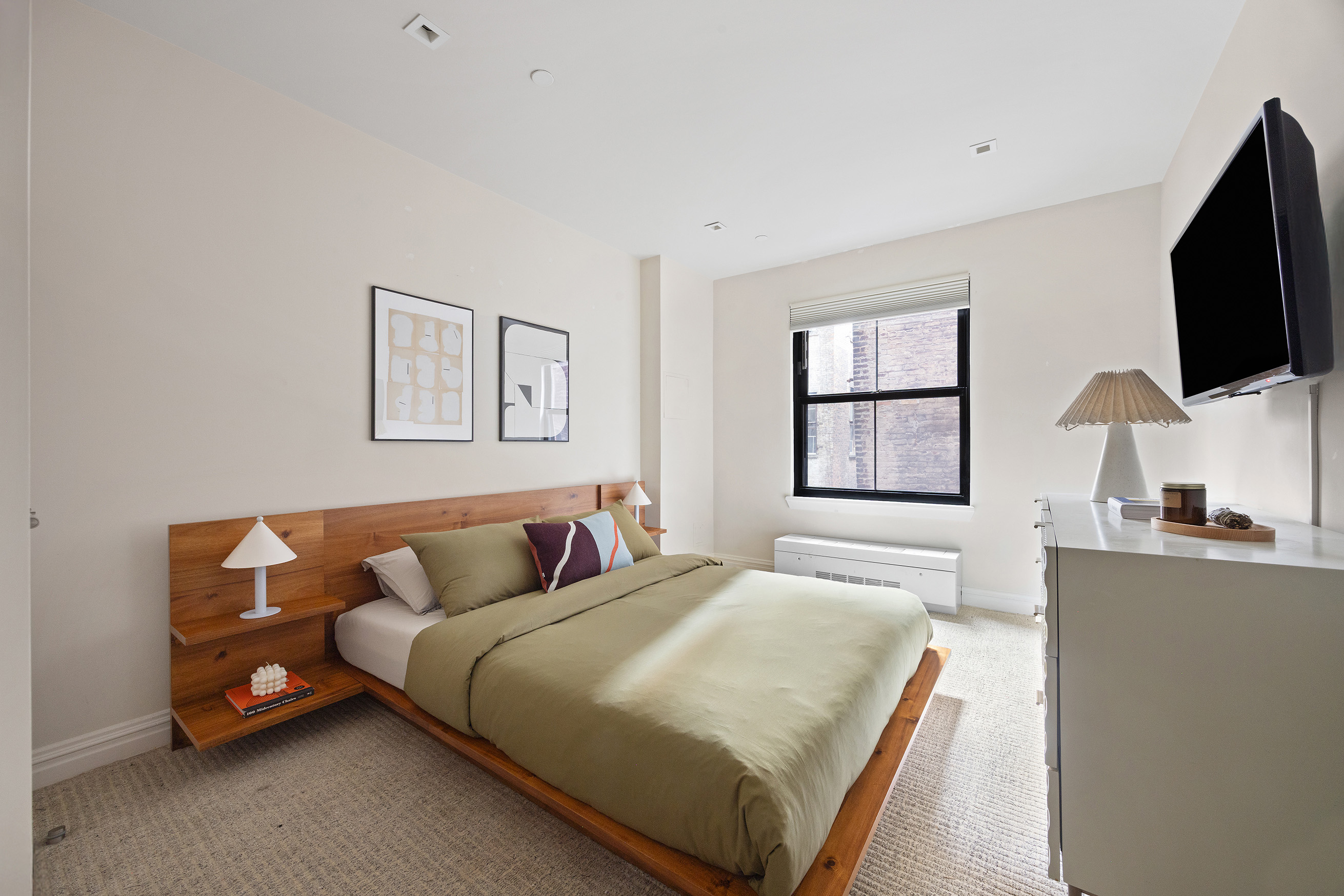 161 Duane Street, Unit 4B Manhattan, NY 10013 - Photo 11 of 16 a bedroom with a bed and a flat screen tv