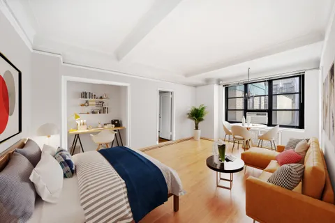 a bedroom with furniture and a large window