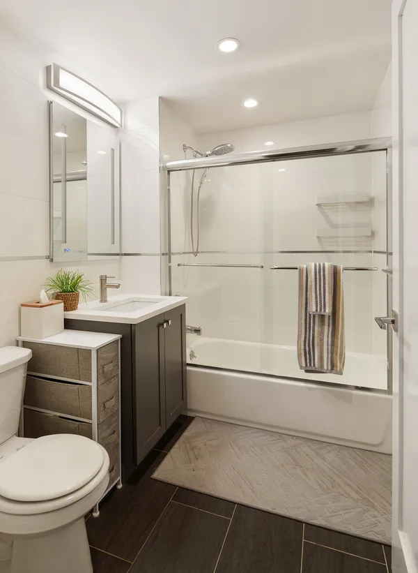a bathroom with a sink toilet and shower