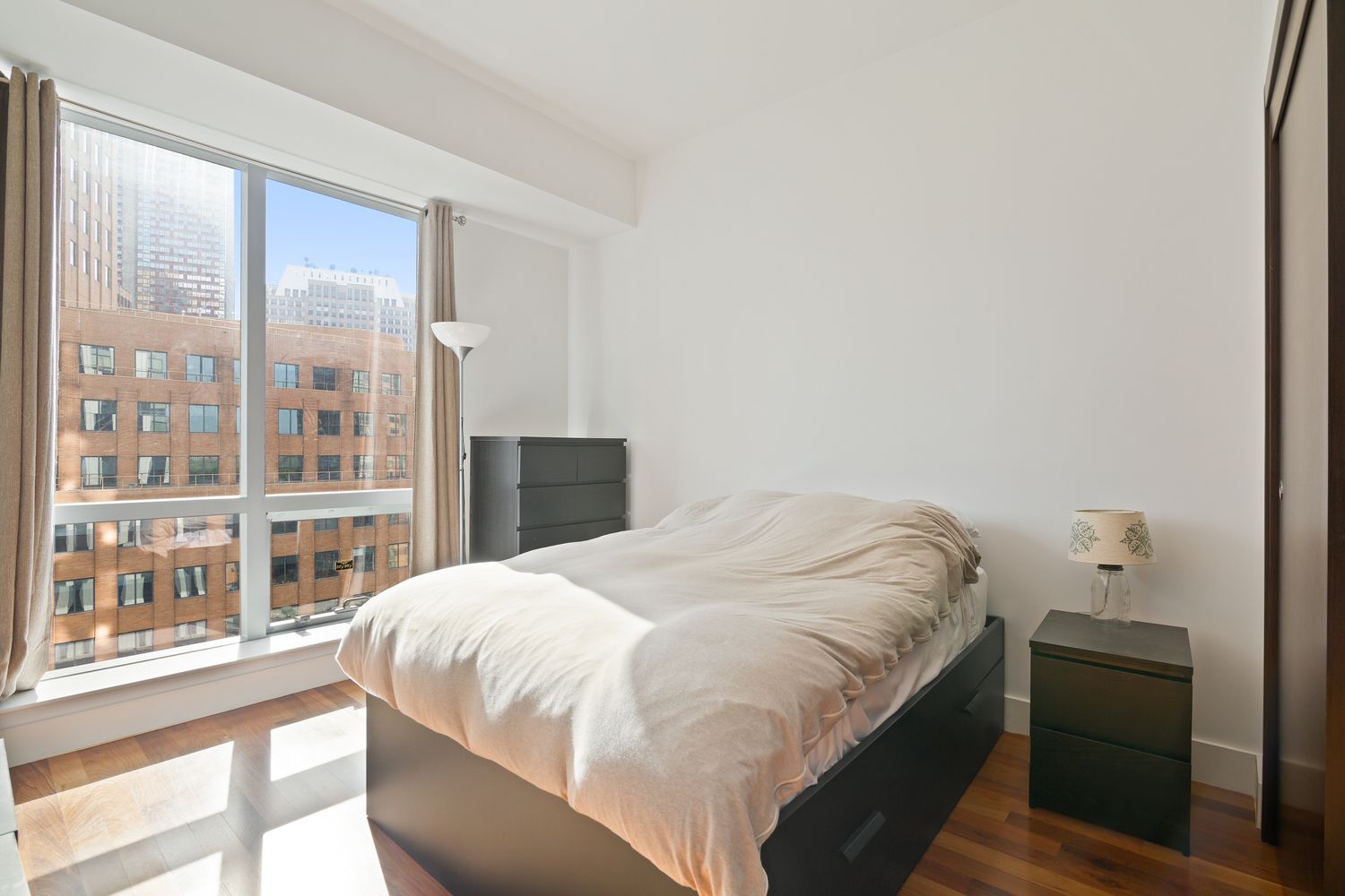 150 Myrtle Avenue, Unit 1005 Brooklyn, NY 11201 - Photo 3 of 21 a bedroom with a bed and a large window