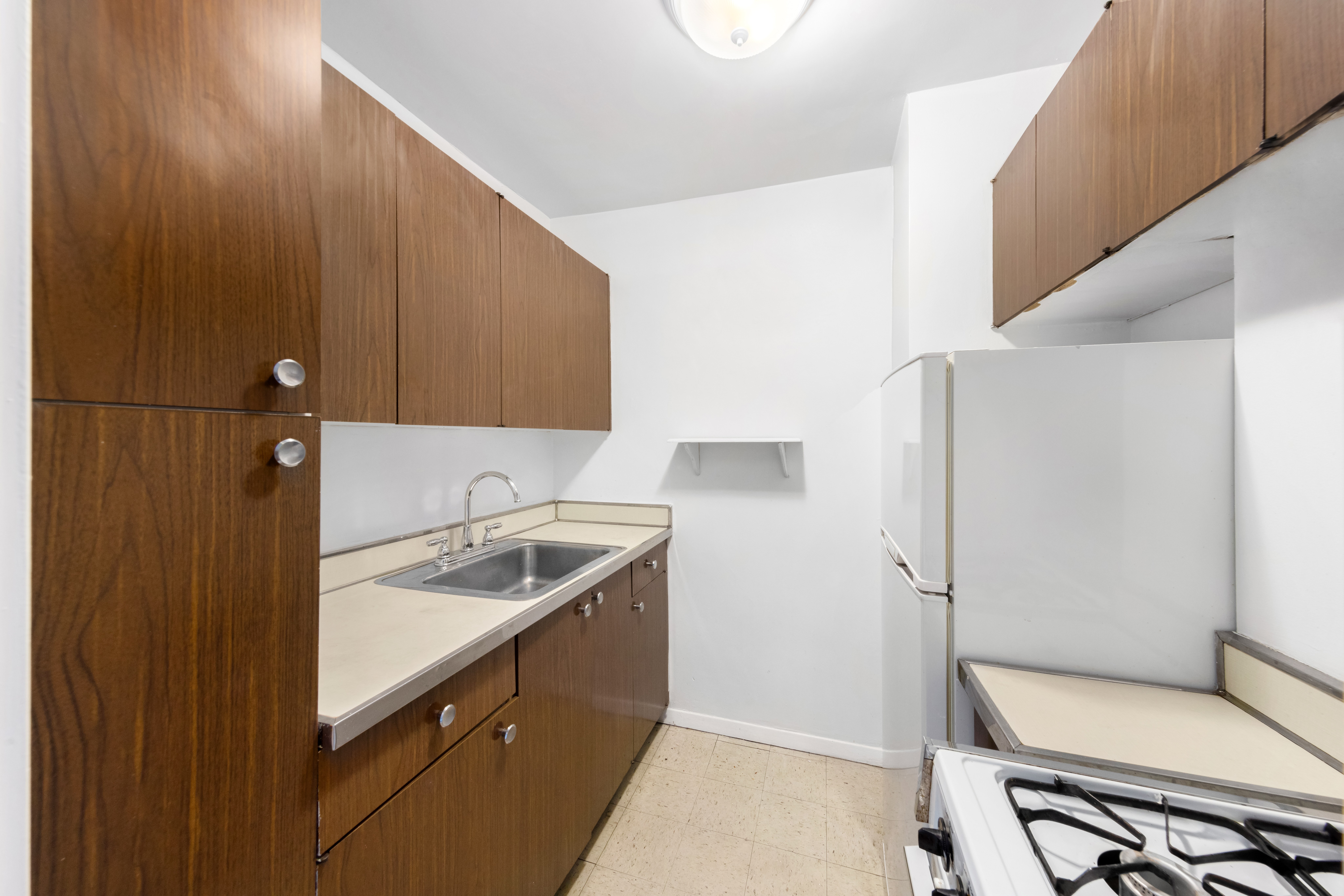 220 East 60th Street, Unit 6A Manhattan, NY 10022 - Photo 3 of 5 a bathroom with a sink and toilet