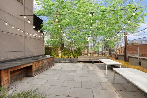 a view of a patio with dining table and chairs with wooden fence
