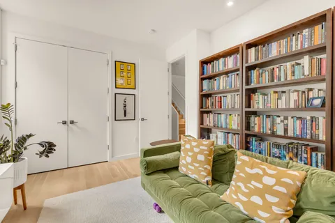 a living room with furniture and book shelf