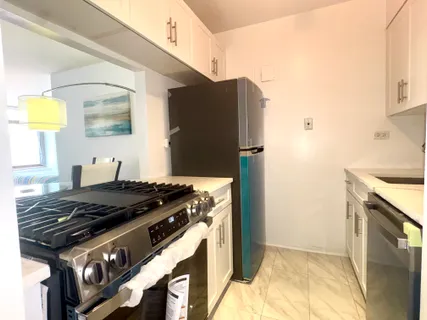 a kitchen with stainless steel appliances granite countertop a stove and a refrigerator