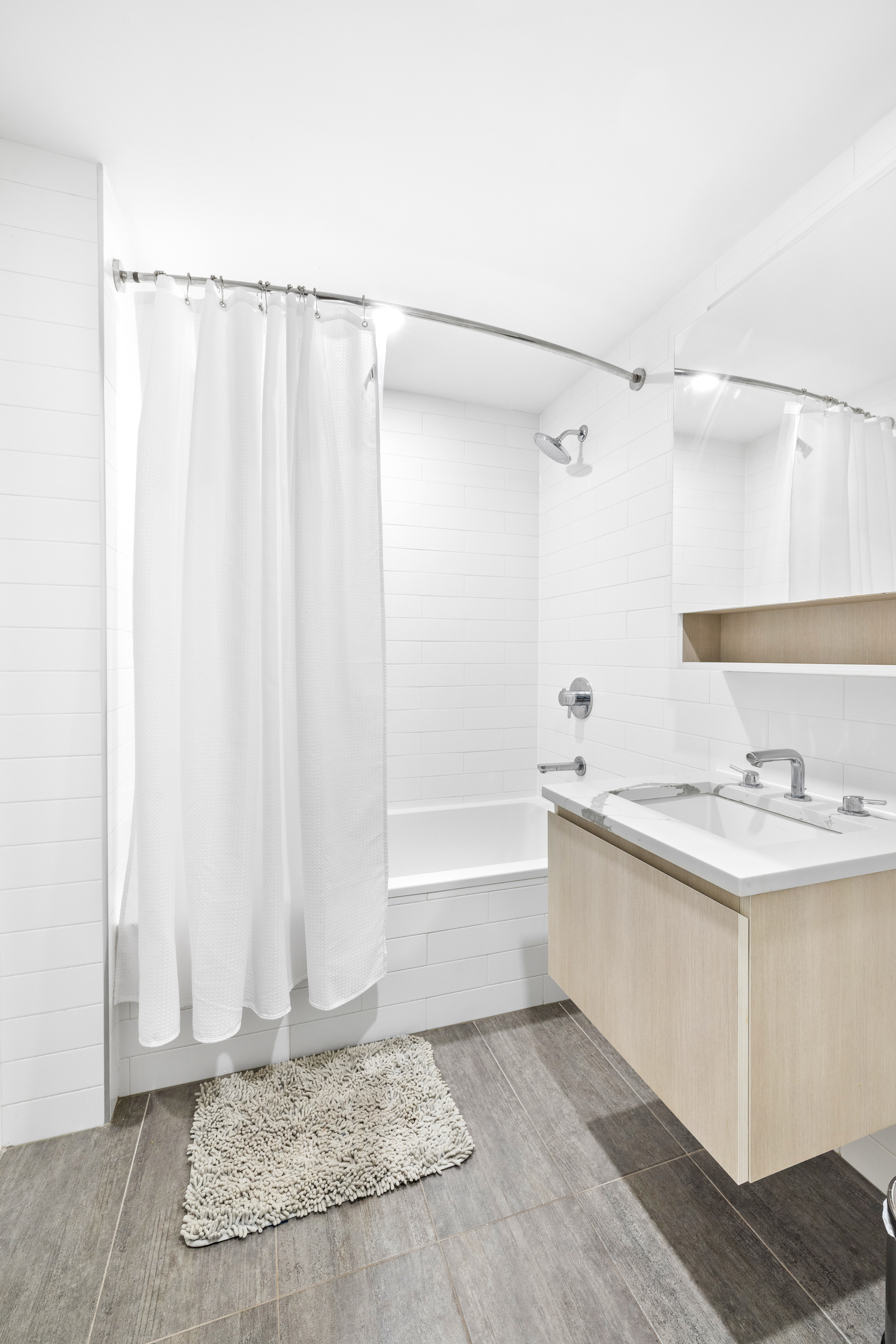 192 Spencer Street, Unit 3A Brooklyn, NY 11205 - Photo 8 of 12 a bathroom with a granite countertop sink and a mirror