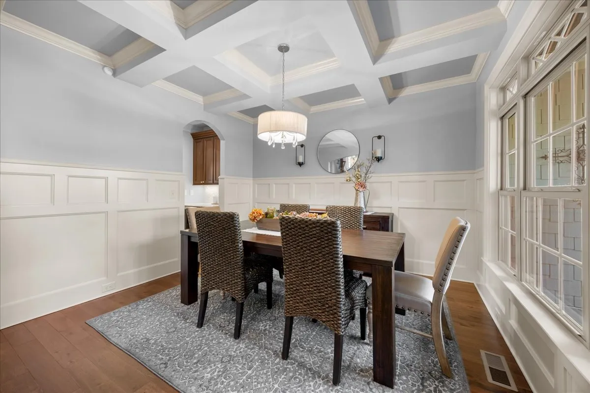 a living room with furniture a chandelier and a fireplace