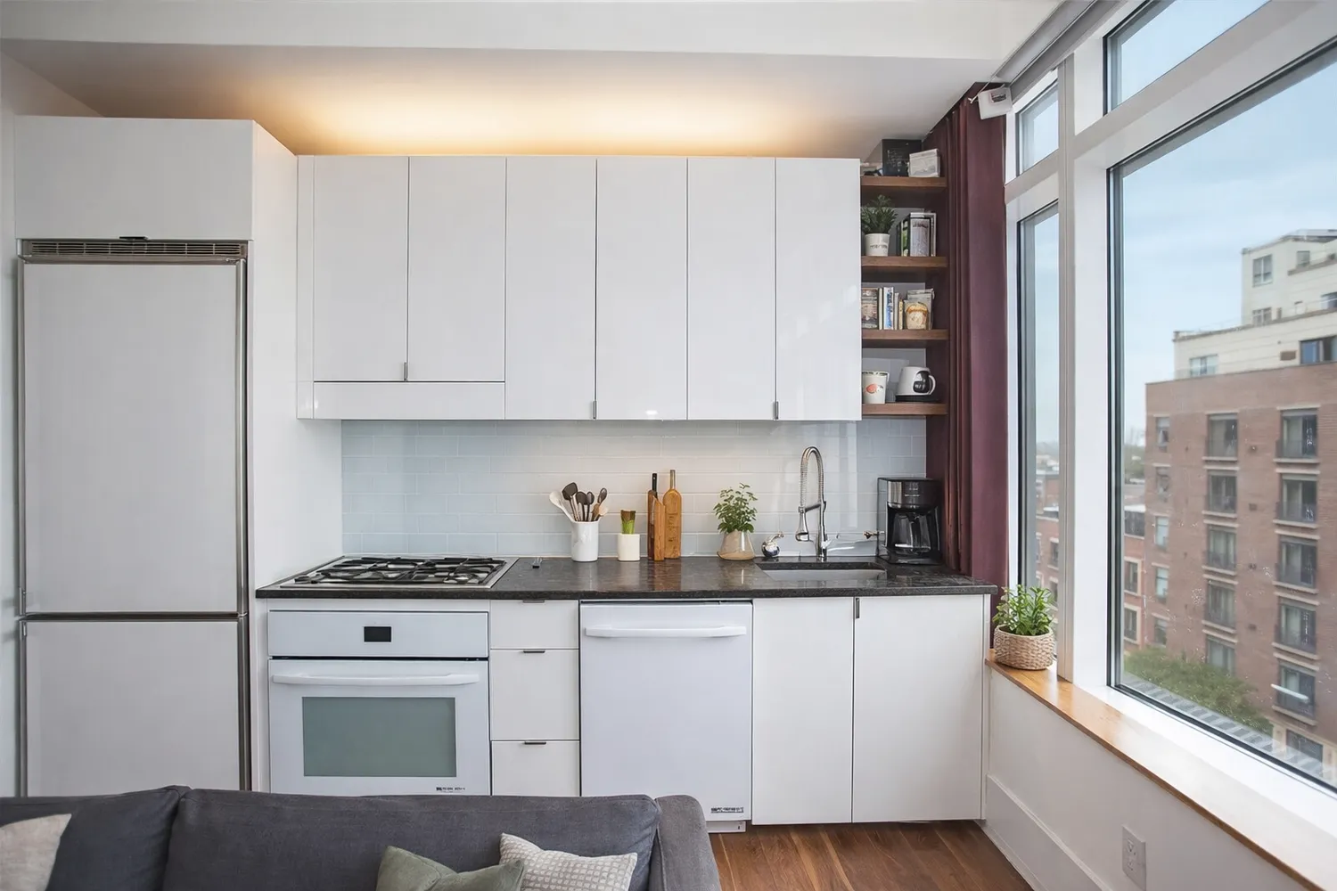 a kitchen with stainless steel appliances granite countertop a refrigerator sink and white cabinets