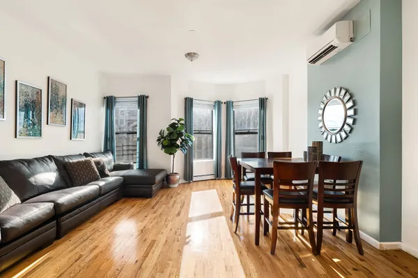 a view of a dining room with furniture and wooden floor