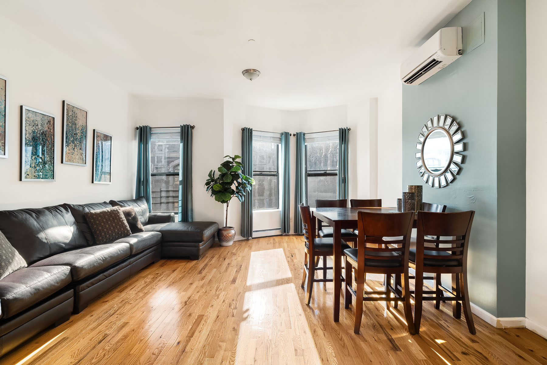 469 West 140th Street, Unit 2 Manhattan, NY 10031 - Photo 2 of 8 a view of a dining room with furniture and wooden floor