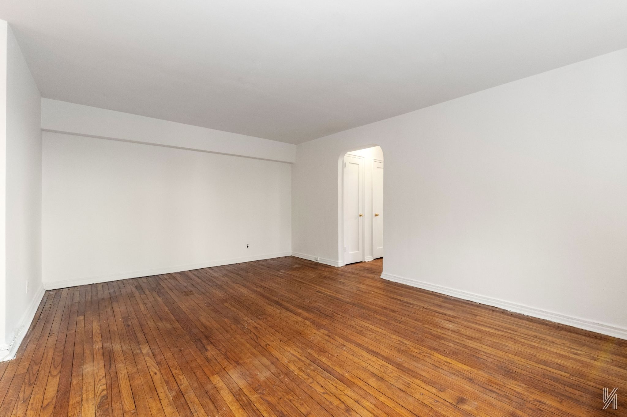 22-60 79th Street, Unit 3E Queens, NY 11370 - Photo 7 of 17 a view of empty room with wooden floor