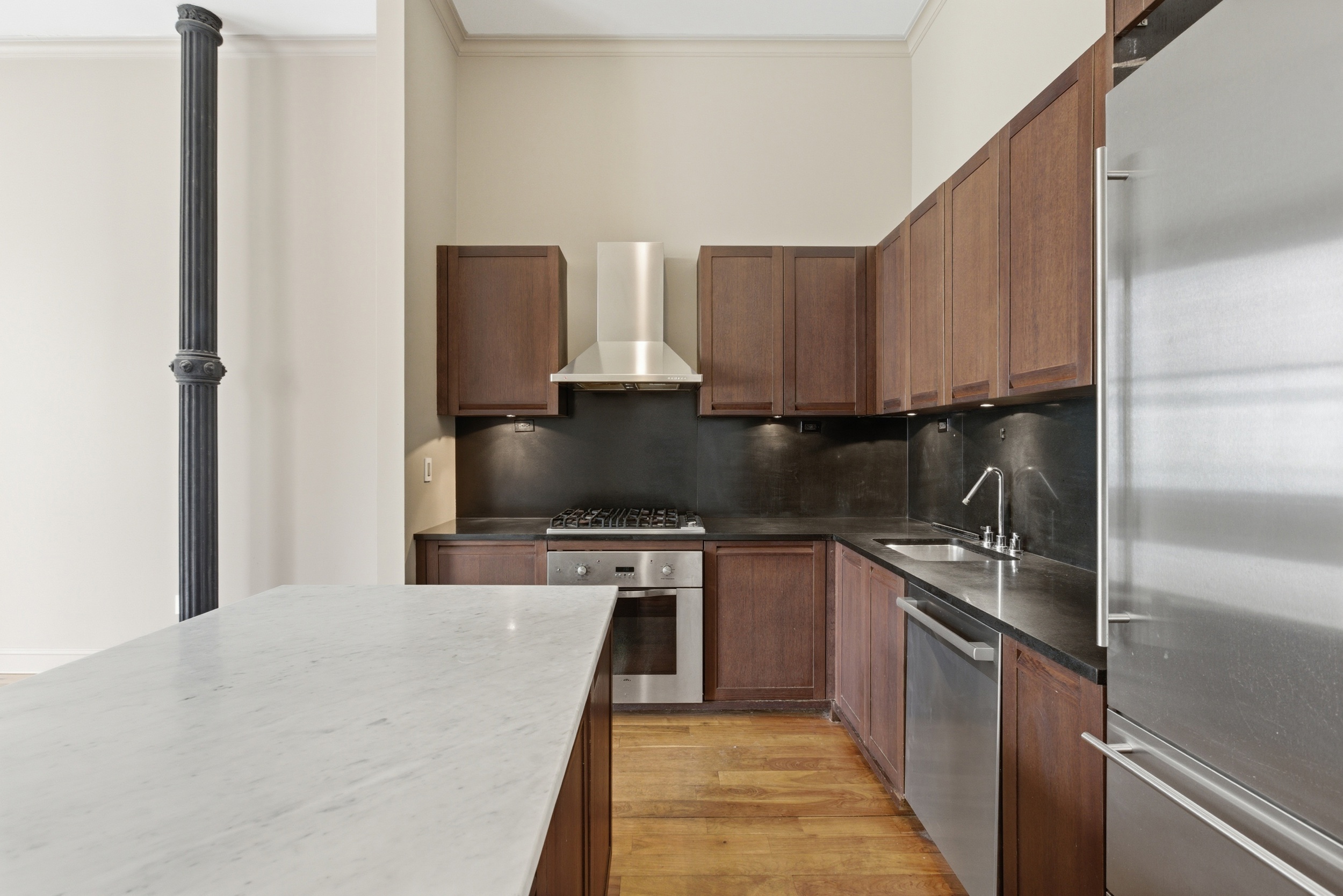 655 6th Avenue, Unit 3D Manhattan, NY 10010 - Photo 6 of 20 a kitchen with stainless steel appliances a sink a stove top oven a counter space and cabinets