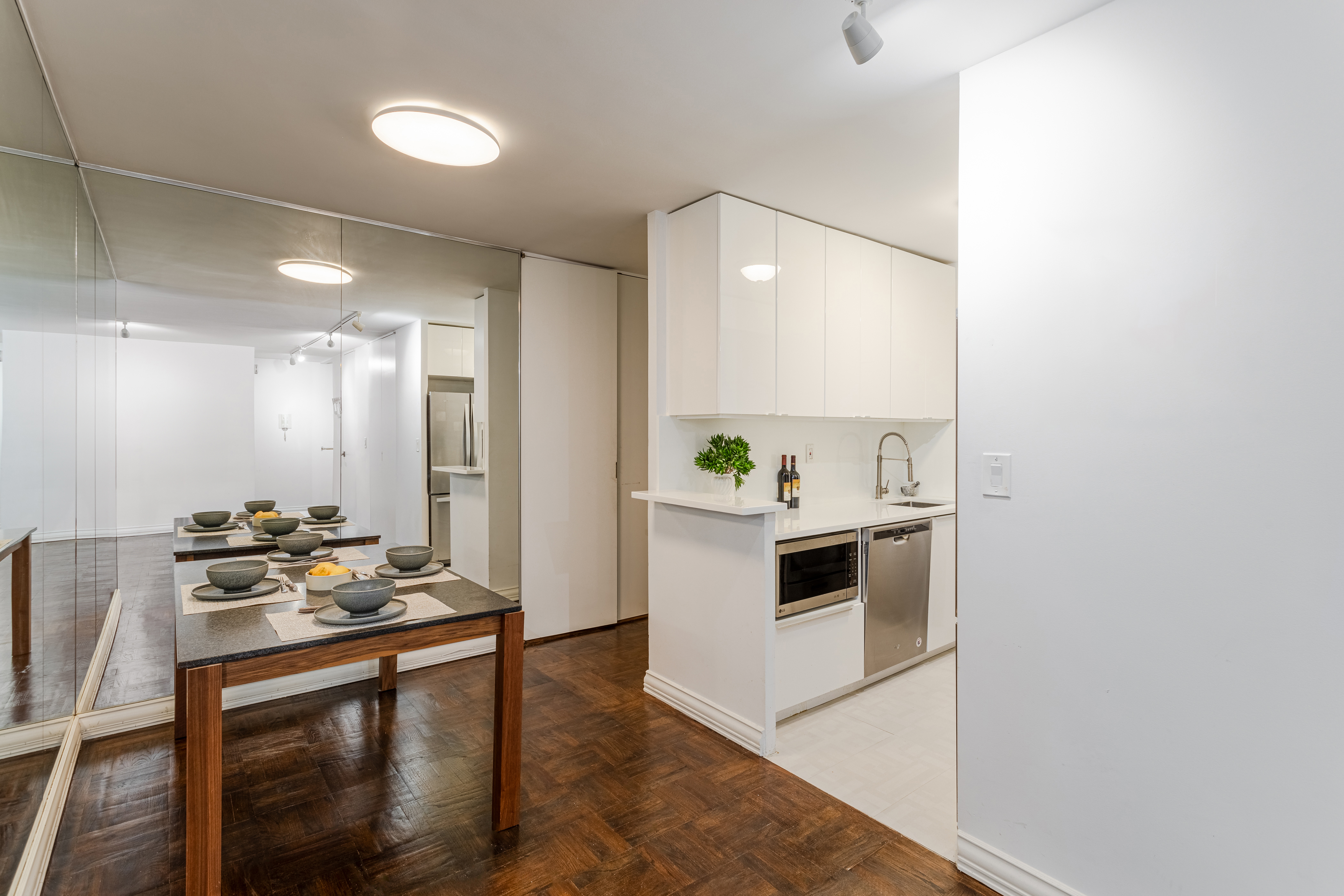 155 East 38th Street, Unit 10D Manhattan, NY 10016 - Photo 9 of 15 a kitchen with stainless steel appliances kitchen island granite countertop a stove a sink and a refrigerator