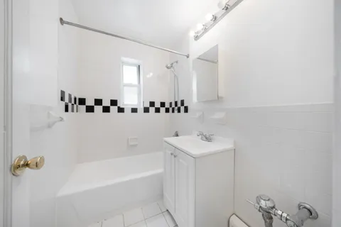 a bathroom with a sink a mirror and a bathtub