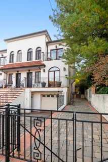 a view of a blue house with large windows