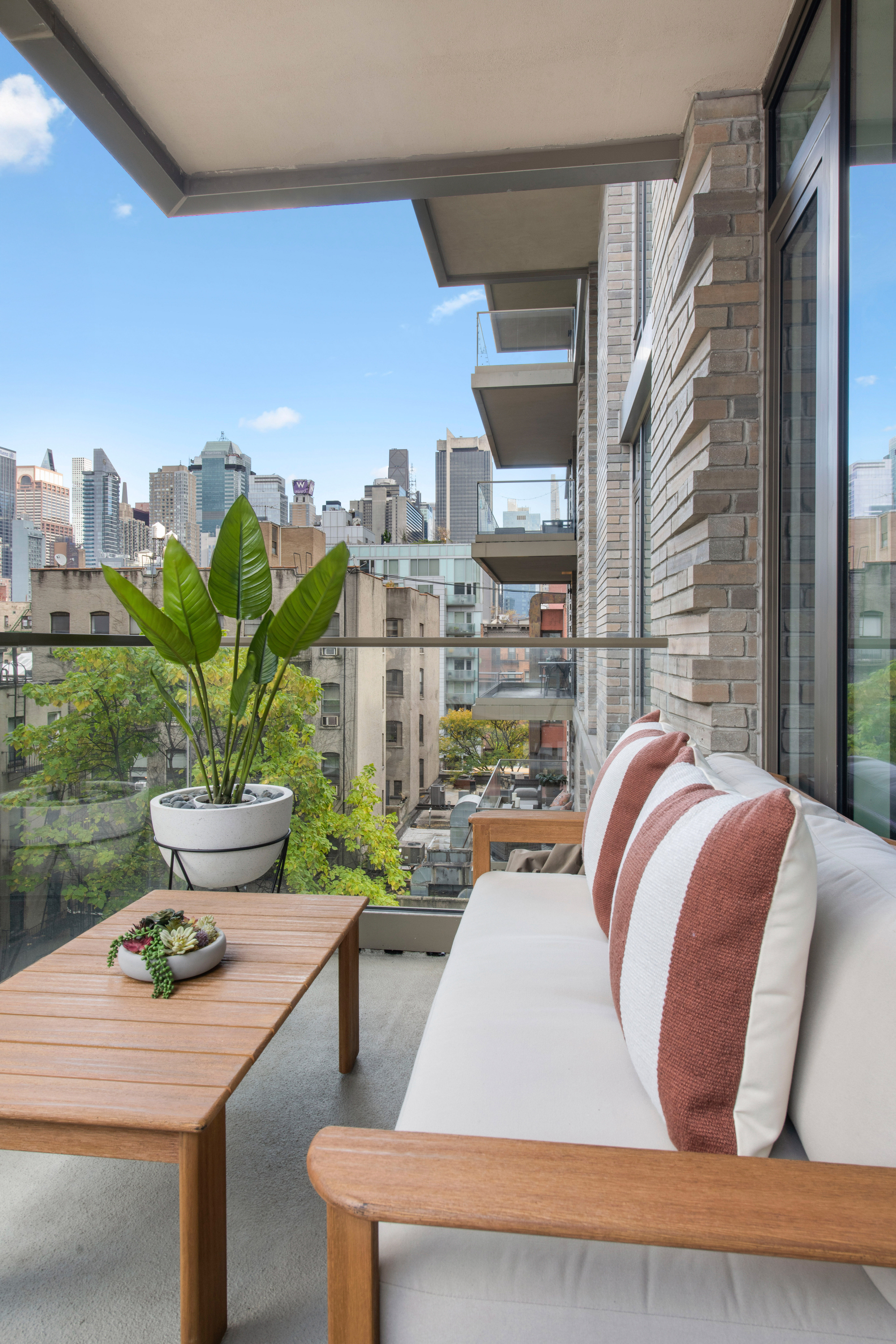 505-513 West 43rd Street, Unit 6K Manhattan, NY 10036 - Photo 5 of 16 a bed sitting in a bedroom next to a window