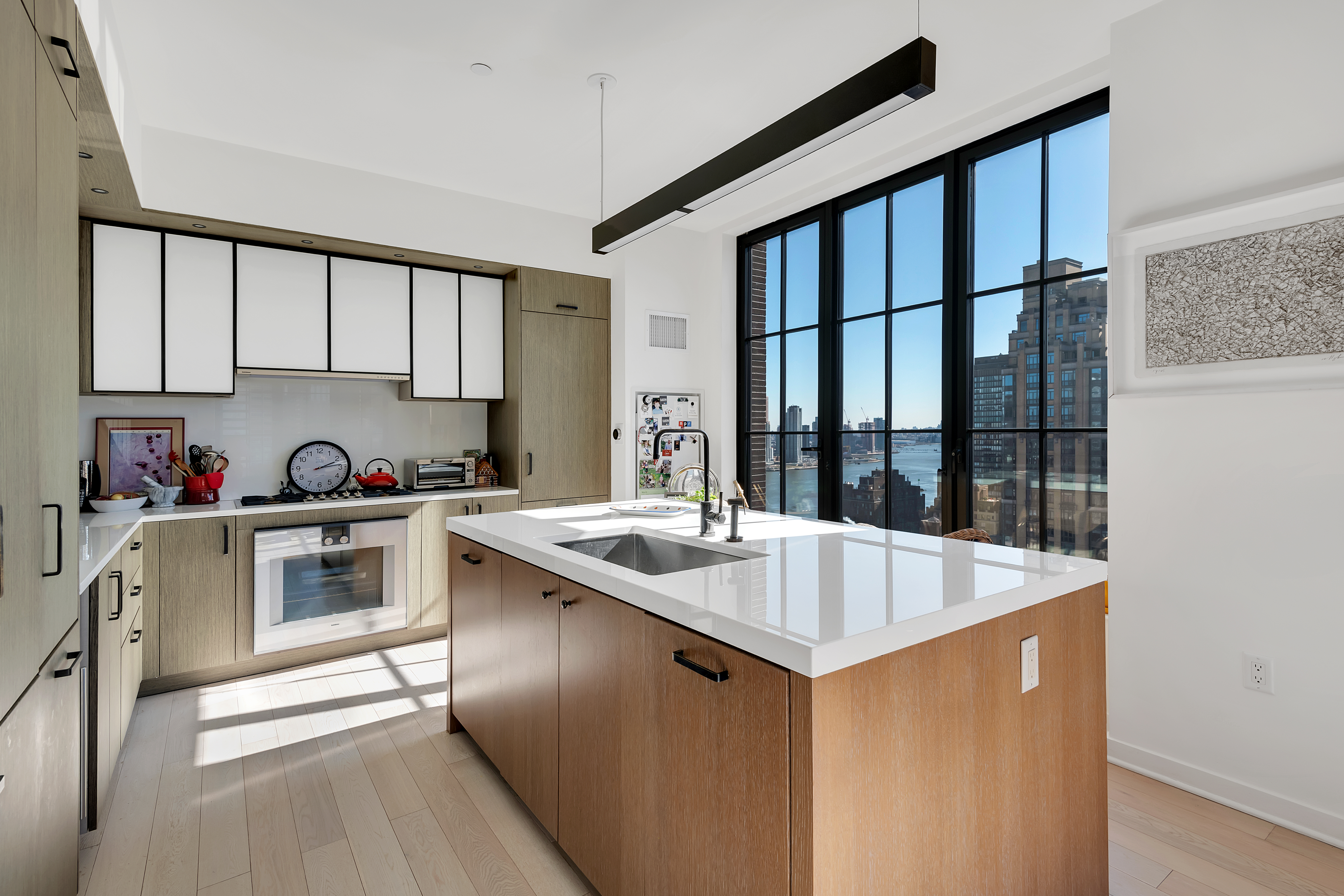 959 1st Avenue, Unit 25H Manhattan, NY 10022 - Photo 5 of 18 a kitchen that has a sink and a stove in it