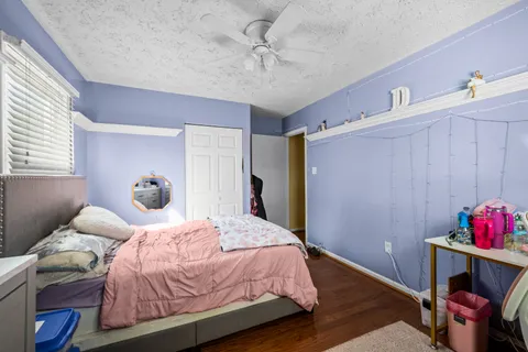 a bedroom with a bed and a potted plant