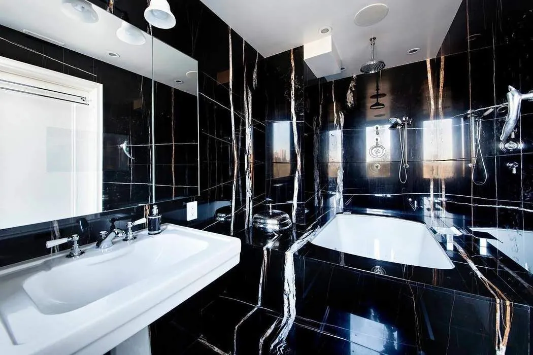 a bathroom with double vanity and a bathtub