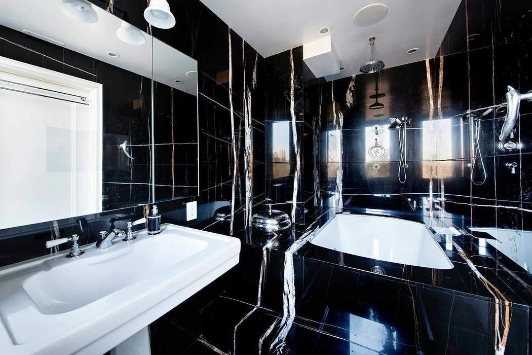 128 Central Park South, Unit 9B Manhattan, NY 10019 - Photo 4 of 11 a bathroom with double vanity and a bathtub