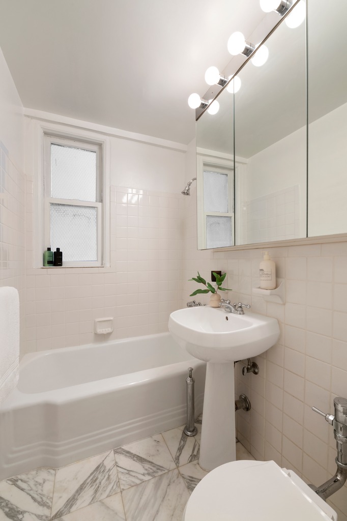251 West 74th Street, Unit 3B Manhattan, NY 10023 - Photo 6 of 7 a bathroom with a sink a toilet and bathtub