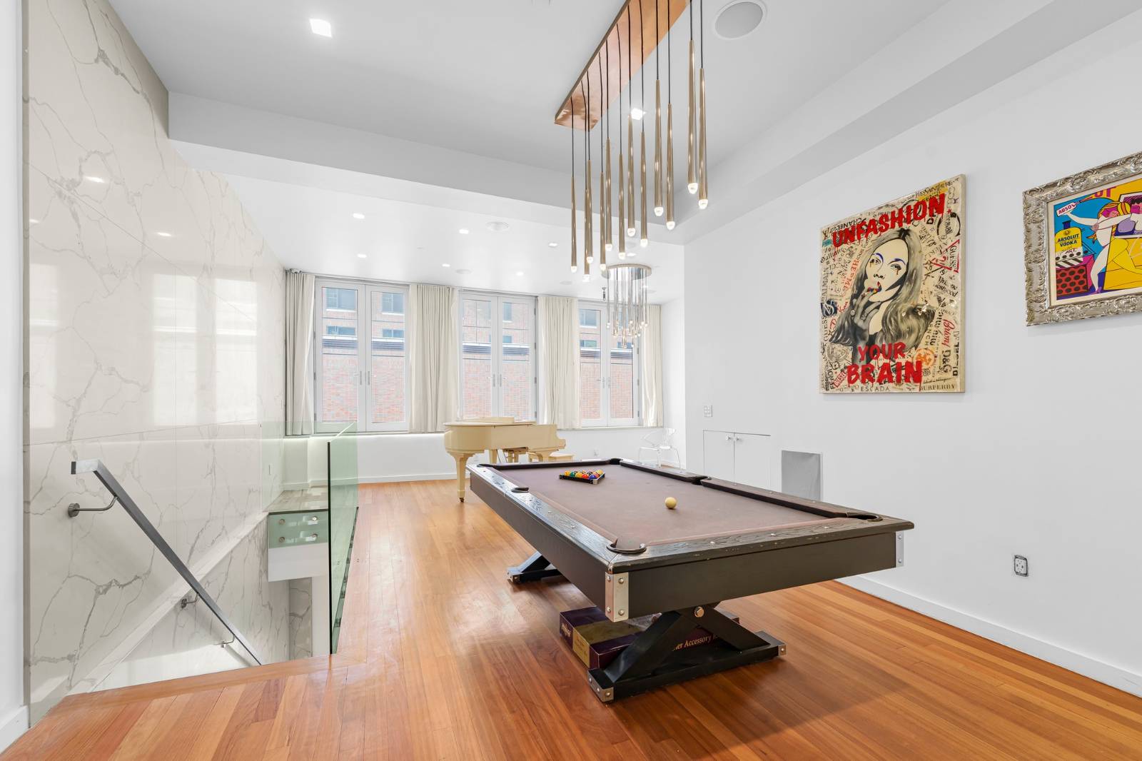 a living room with table tennis pool table and chairs