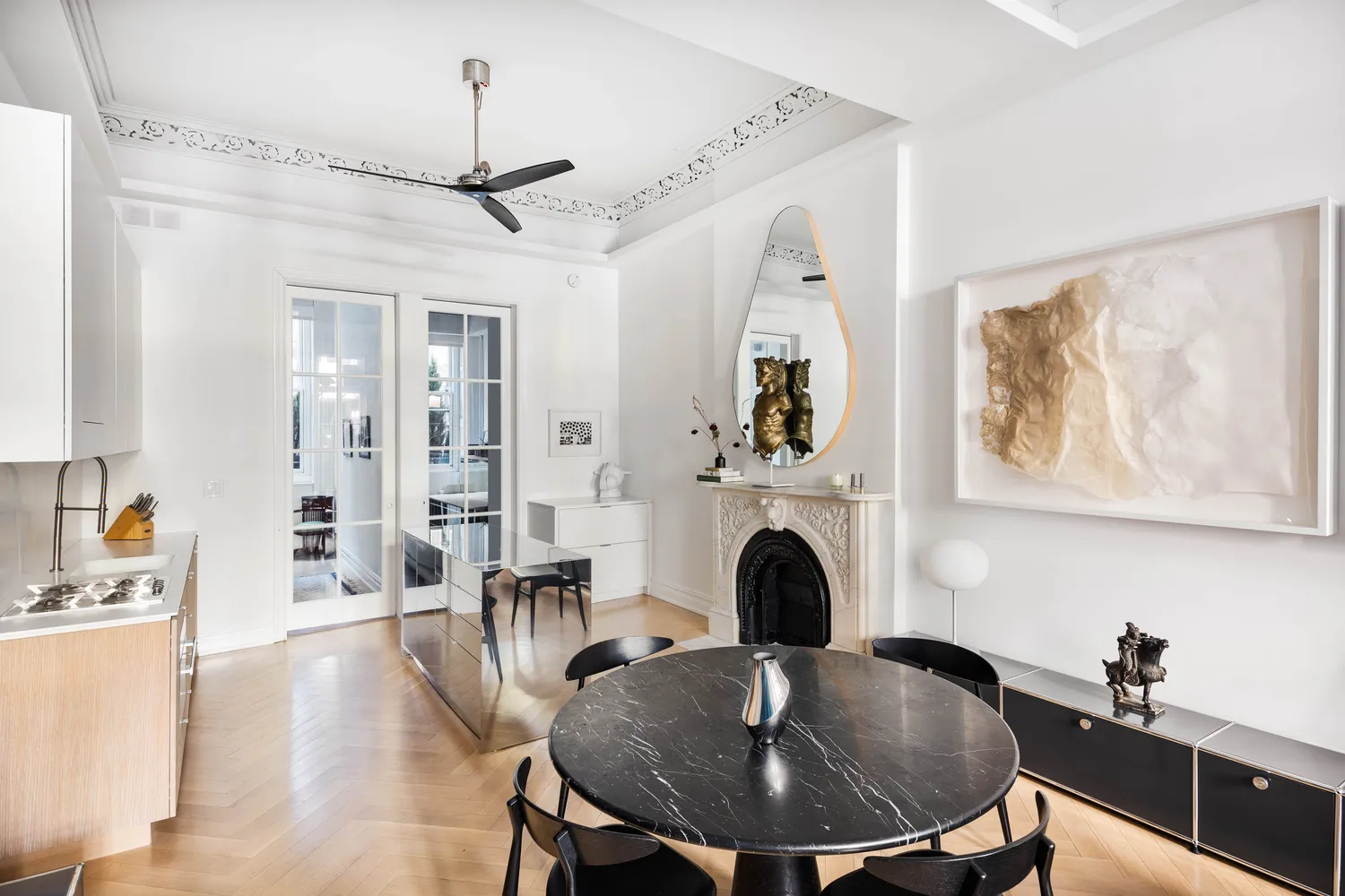 a view of a dining room with furniture wooden floor and a chandelier