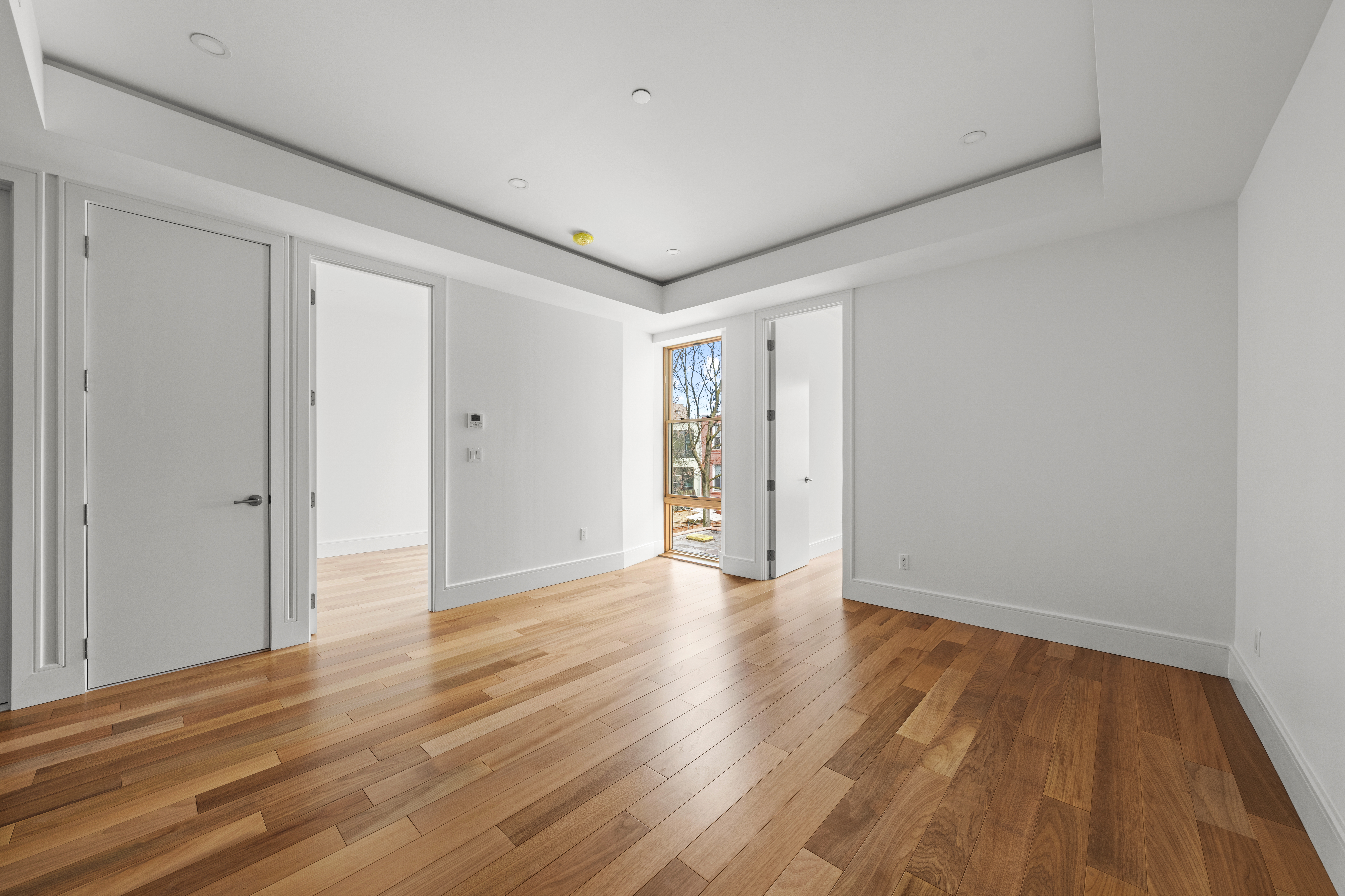 82 Cooper Street, Unit 2B Brooklyn, NY 11207 - Photo 15 of 17 a view of an empty room with wooden floor and closet