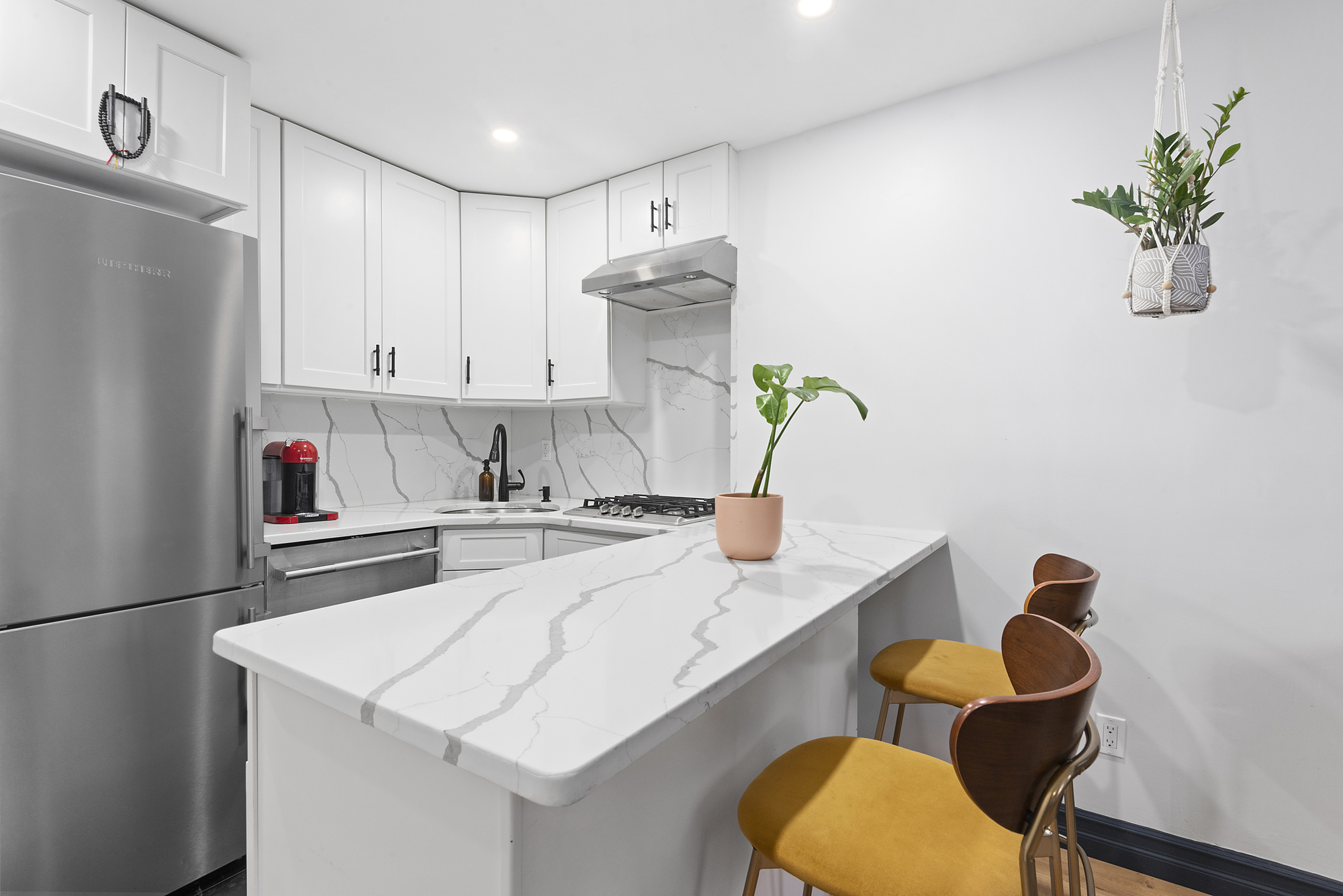 365 Bainbridge Street, Unit 1 Brooklyn, NY 11233 - Photo 2 of 8 a kitchen with stainless steel appliances granite countertop sink stove refrigerator and cabinets