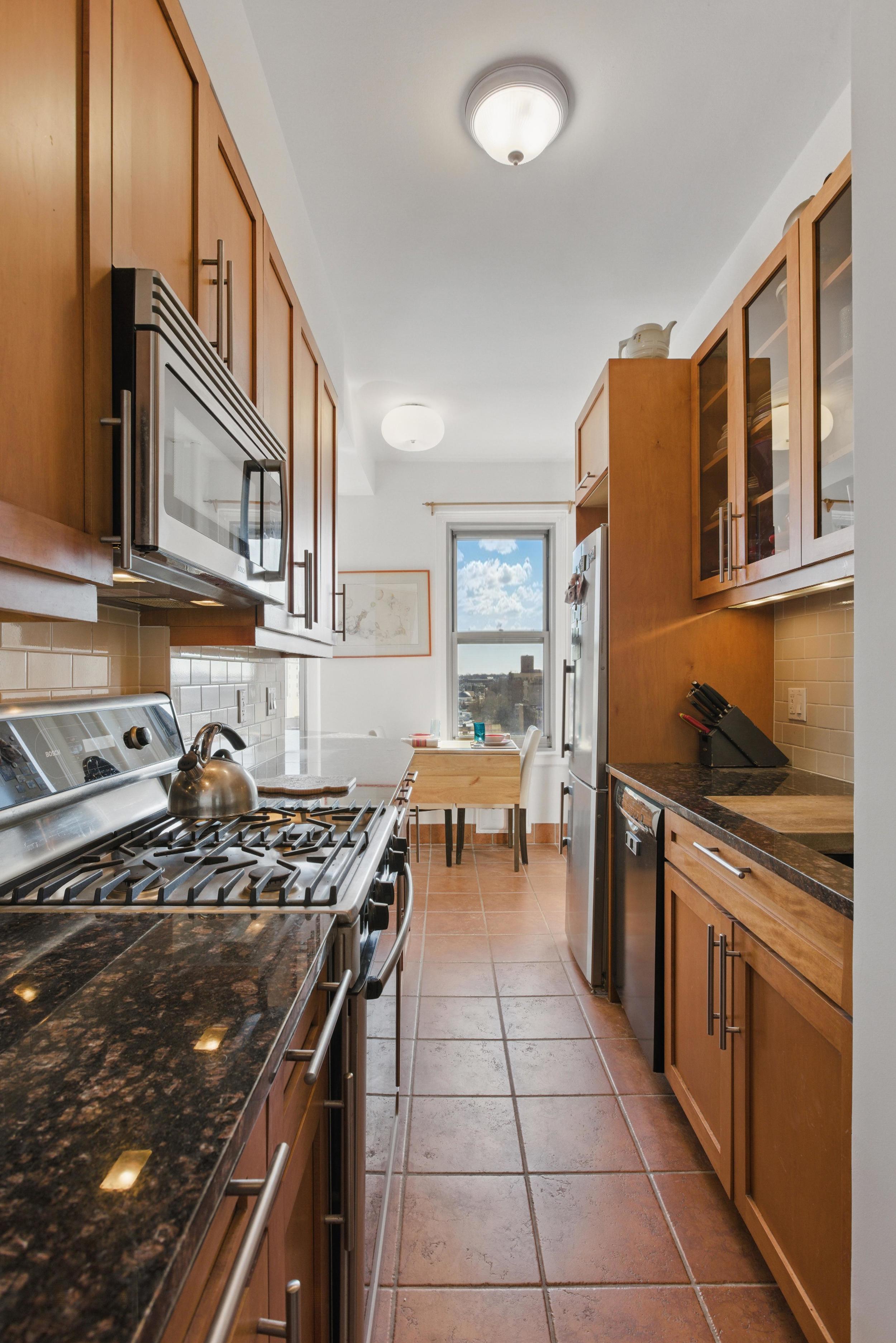 1 Plaza Street West, Unit 12C Brooklyn, NY 11217 - Photo 4 of 13 a kitchen with a stove a sink and a refrigerator