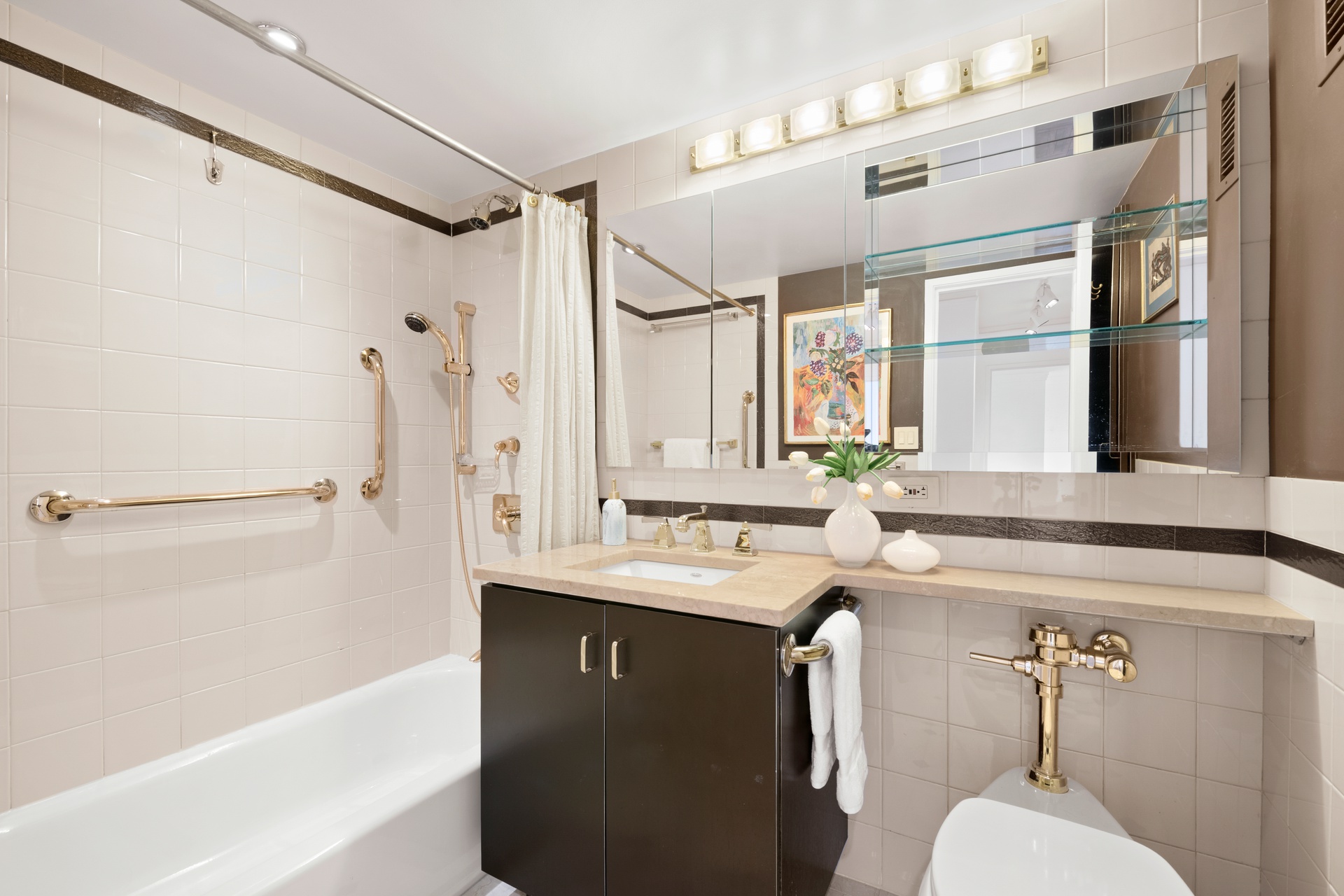 70 East 10th Street, Unit 20C Manhattan, NY 10003 - Photo 15 of 24 a bathroom with a sink a mirror and a bathtub