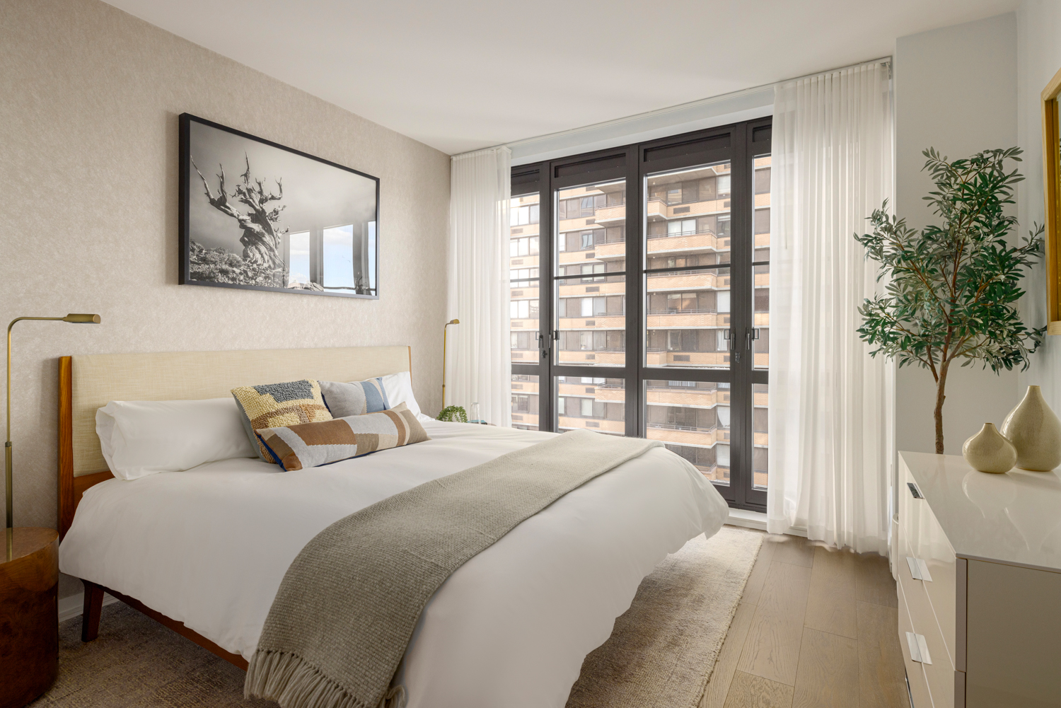 250 West 96th Street, Unit 10B Manhattan, NY 10025 - Photo 5 of 25 a bedroom with a large bed and a large window with outer view