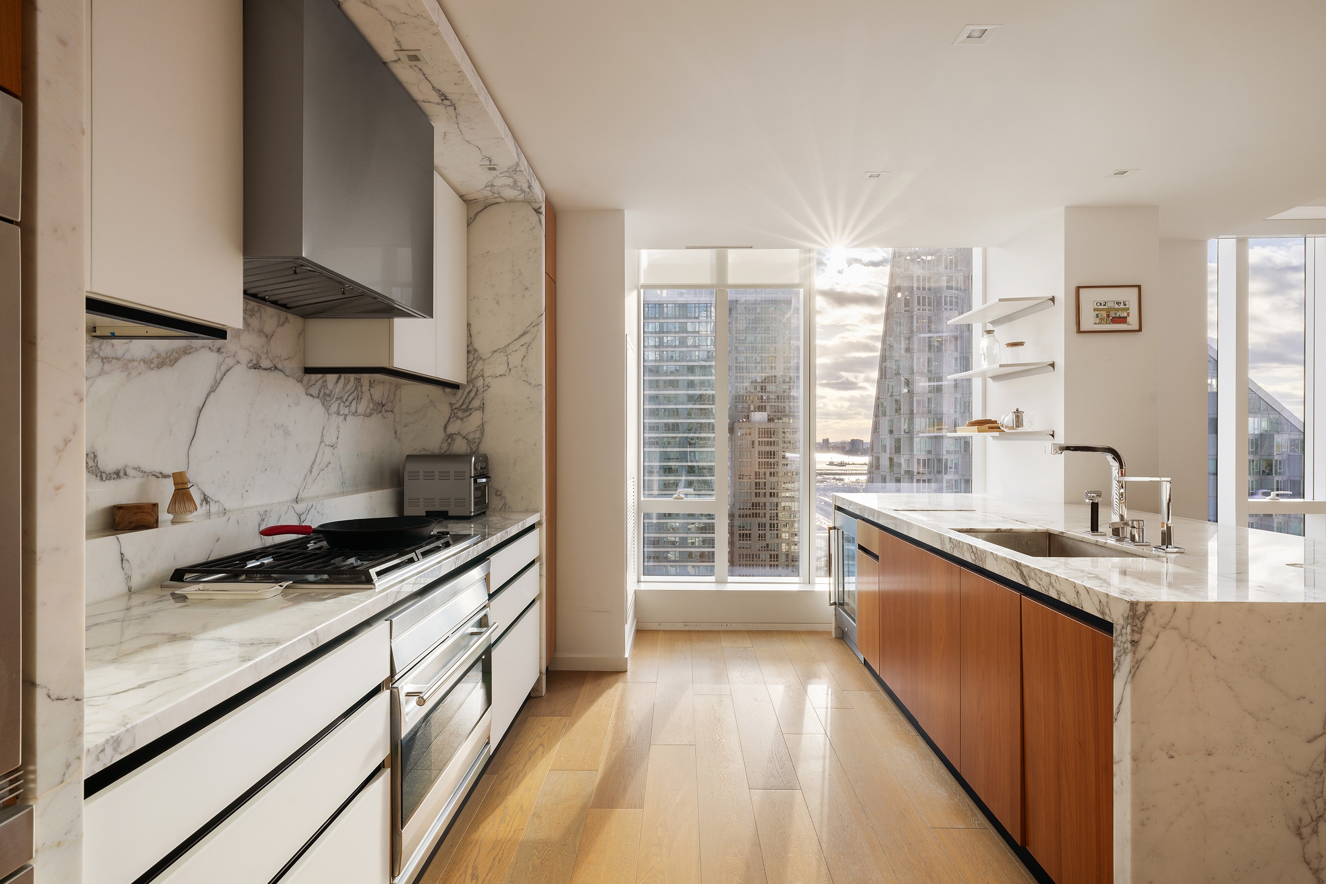 1 West End Avenue, Unit 25F Manhattan, NY 10023 - Photo 5 of 15 a kitchen with stainless steel appliances granite countertop a sink stove and cabinets
