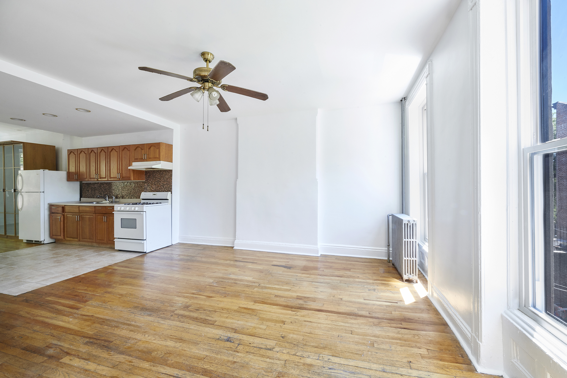 276 Stuyvesant Avenue, Unit 2 Brooklyn, NY 11221 - Photo 2 of 11 a view of a kitchen with a sink and a refrigerator