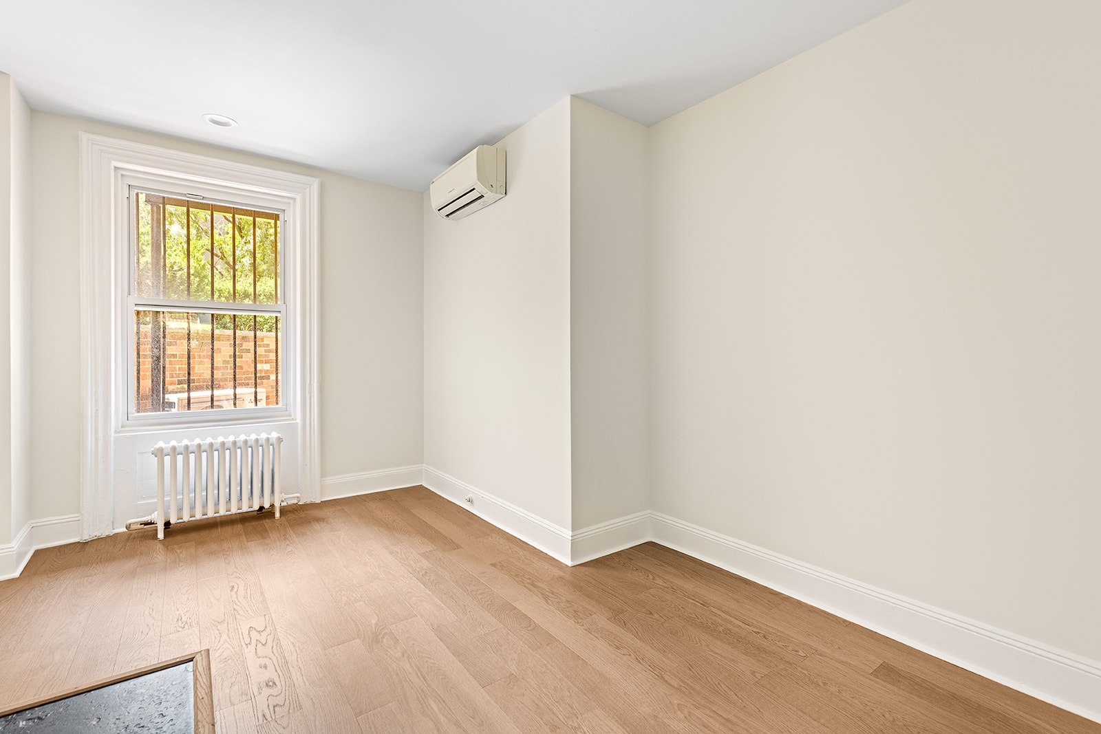 370 Carlton Avenue, Unit GARDEN Brooklyn, NY 11238 - Photo 4 of 7 an empty room with wooden floor and windows