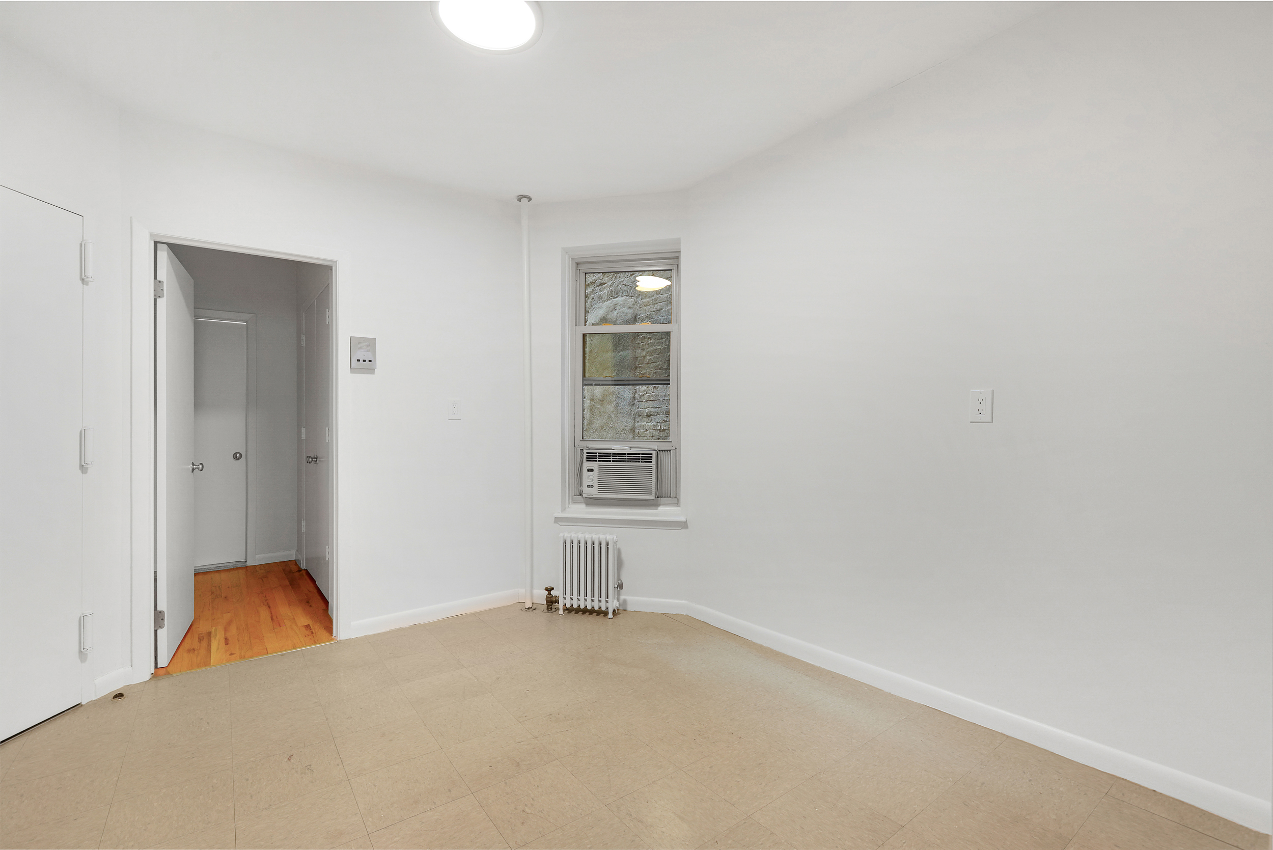323 West 43rd Street, Unit 4R Manhattan, NY 10036 - Photo 8 of 14 a view of empty room with windows