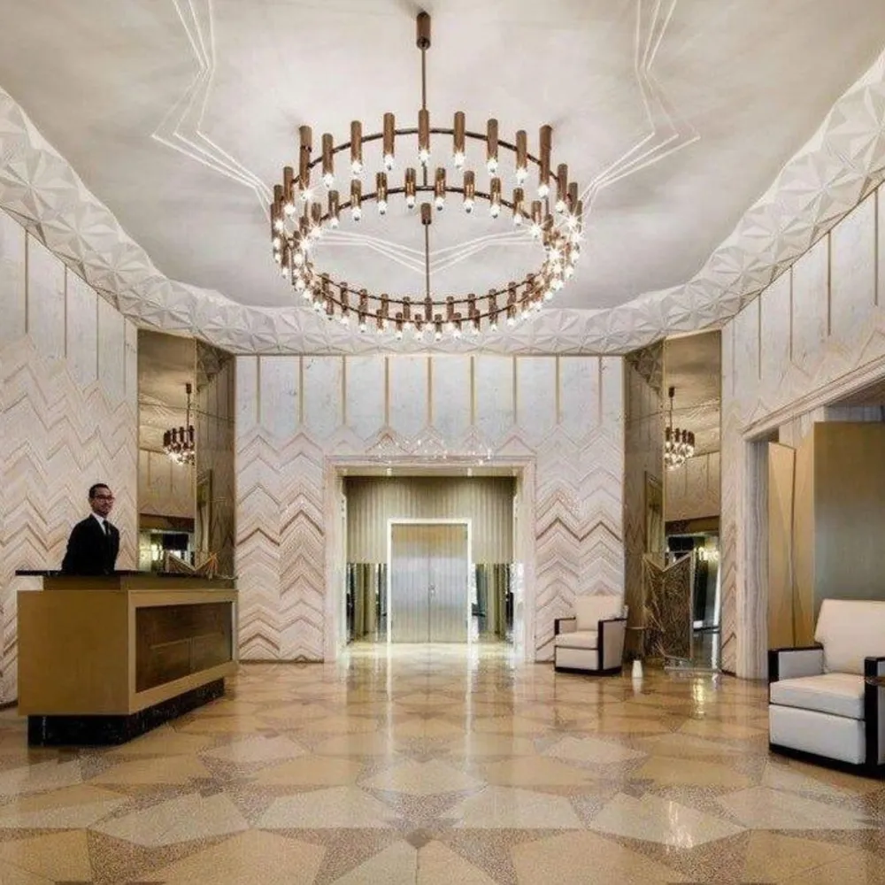 a view of a lobby with a couch and a chandelier