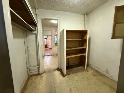 an empty room with windows and fireplace