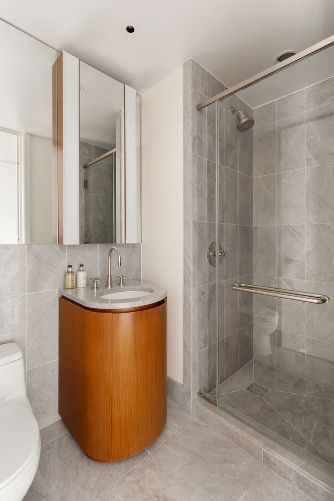 a bathroom with a sink toilet and shower
