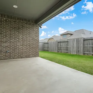 a view of a house with a yard and sitting area