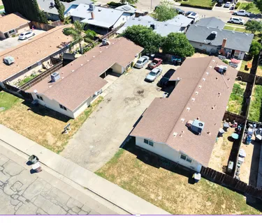 an aerial view of a house with a yard
