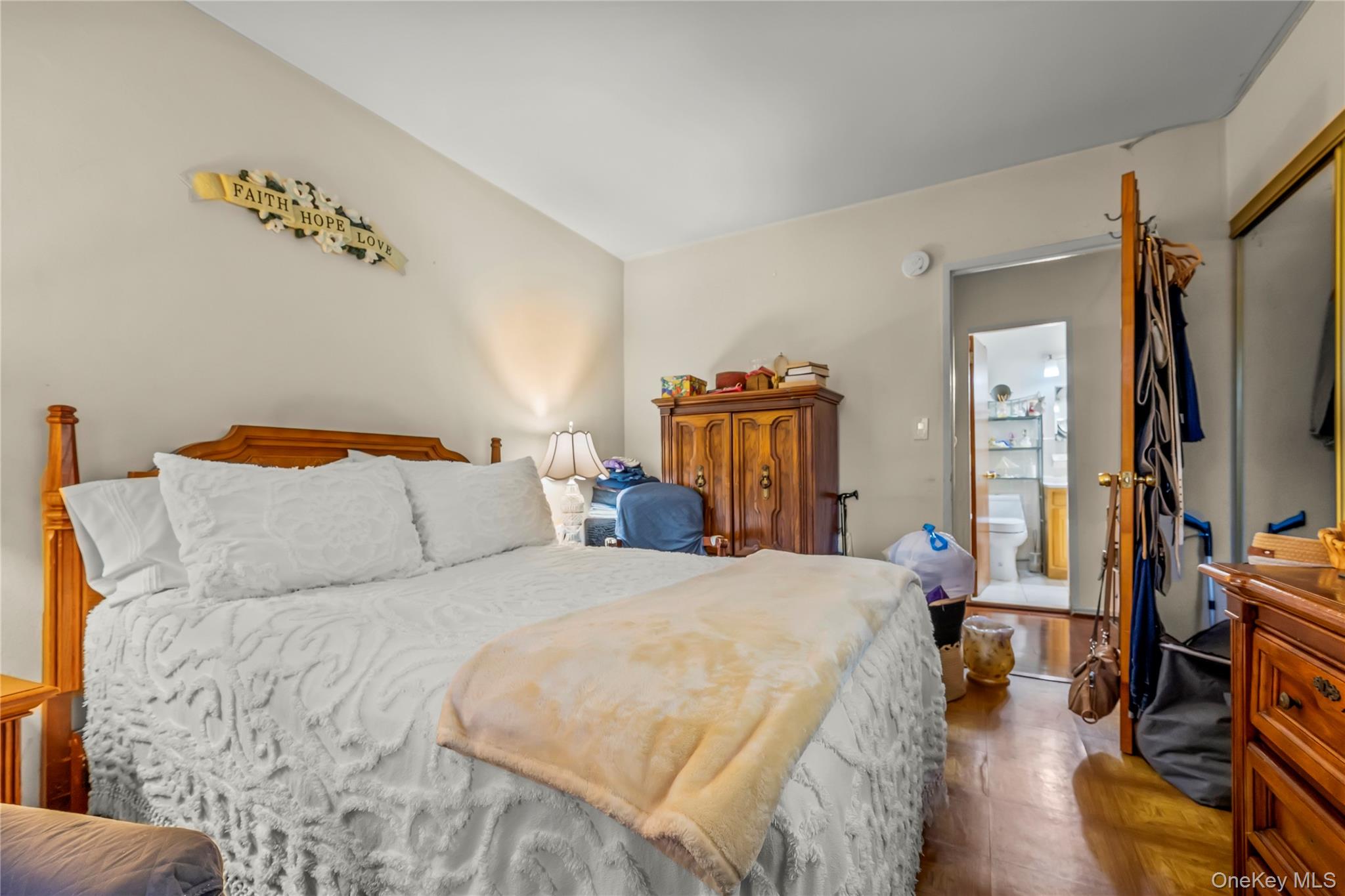 12399 Flatlands Avenue, Unit 1L Brooklyn, NY 11207 - Photo 11 of 21 a bedroom with a bed and a flat tv screen on dresser
