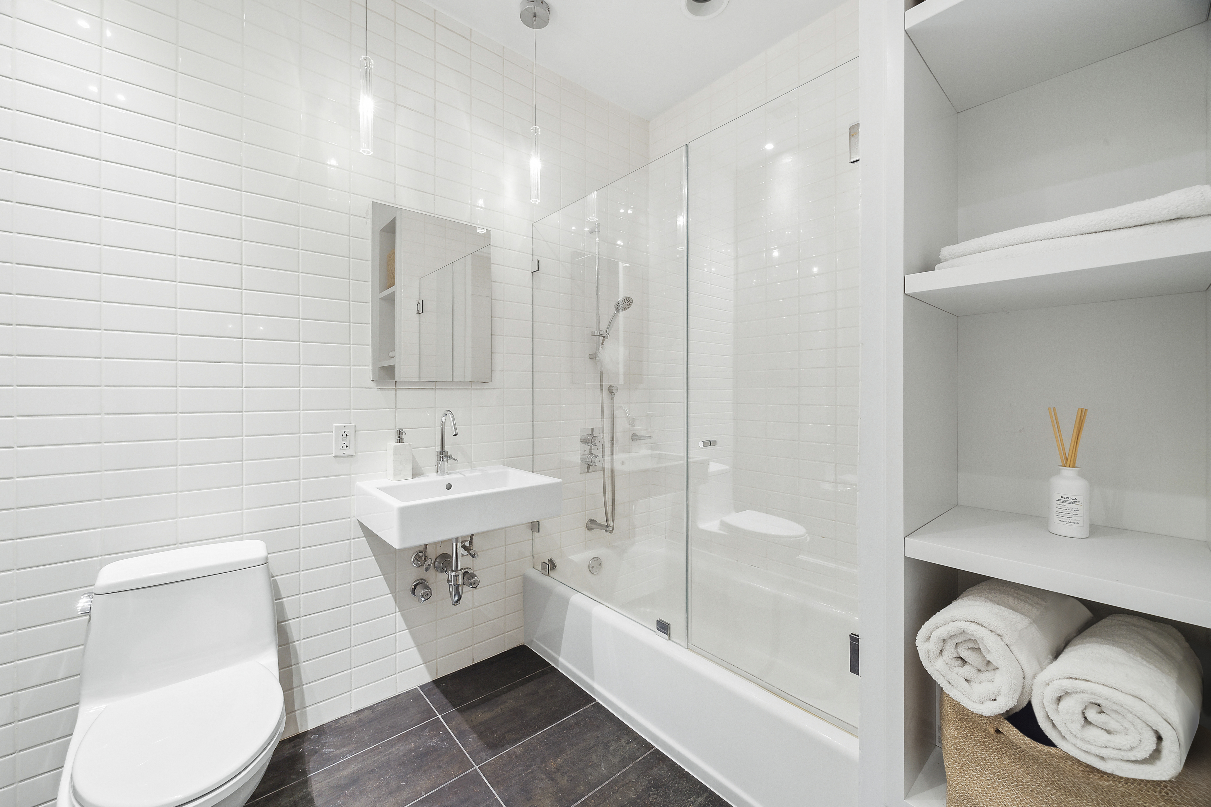 420 West 25th Street, Unit TH1E Manhattan, NY 10001 - Photo 15 of 22 a bathroom with a bathtub shower sink and toilet