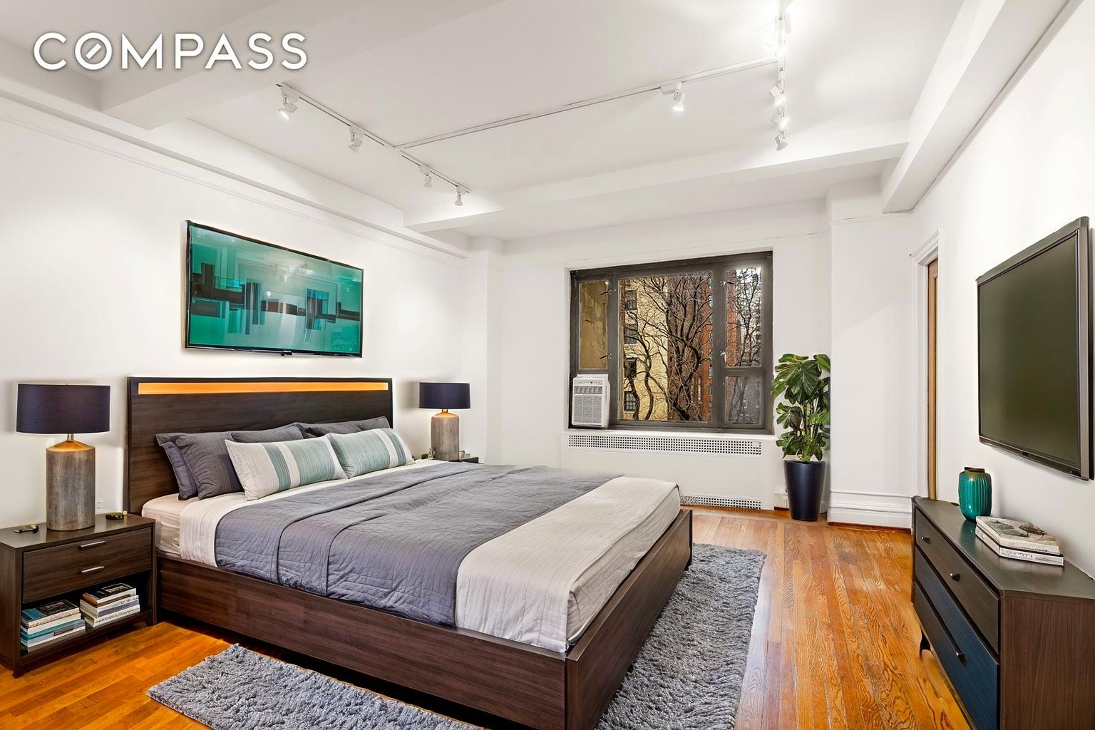 180 East 79th Street, Unit 5A Manhattan, NY 10075 - Photo 9 of 19 a bedroom with bed tv and window