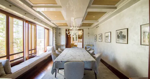 a view of a dining room with furniture and a chandelier