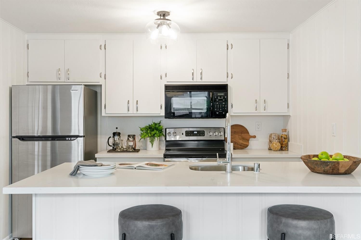460 Francisco Street, Unit 103 San Francisco, CA 94133 - Photo 6 of 8 a kitchen with stainless steel appliances a sink a stove a microwave and refrigerator