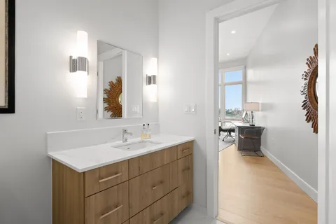 a en suite bathroom with a sink and a mirror