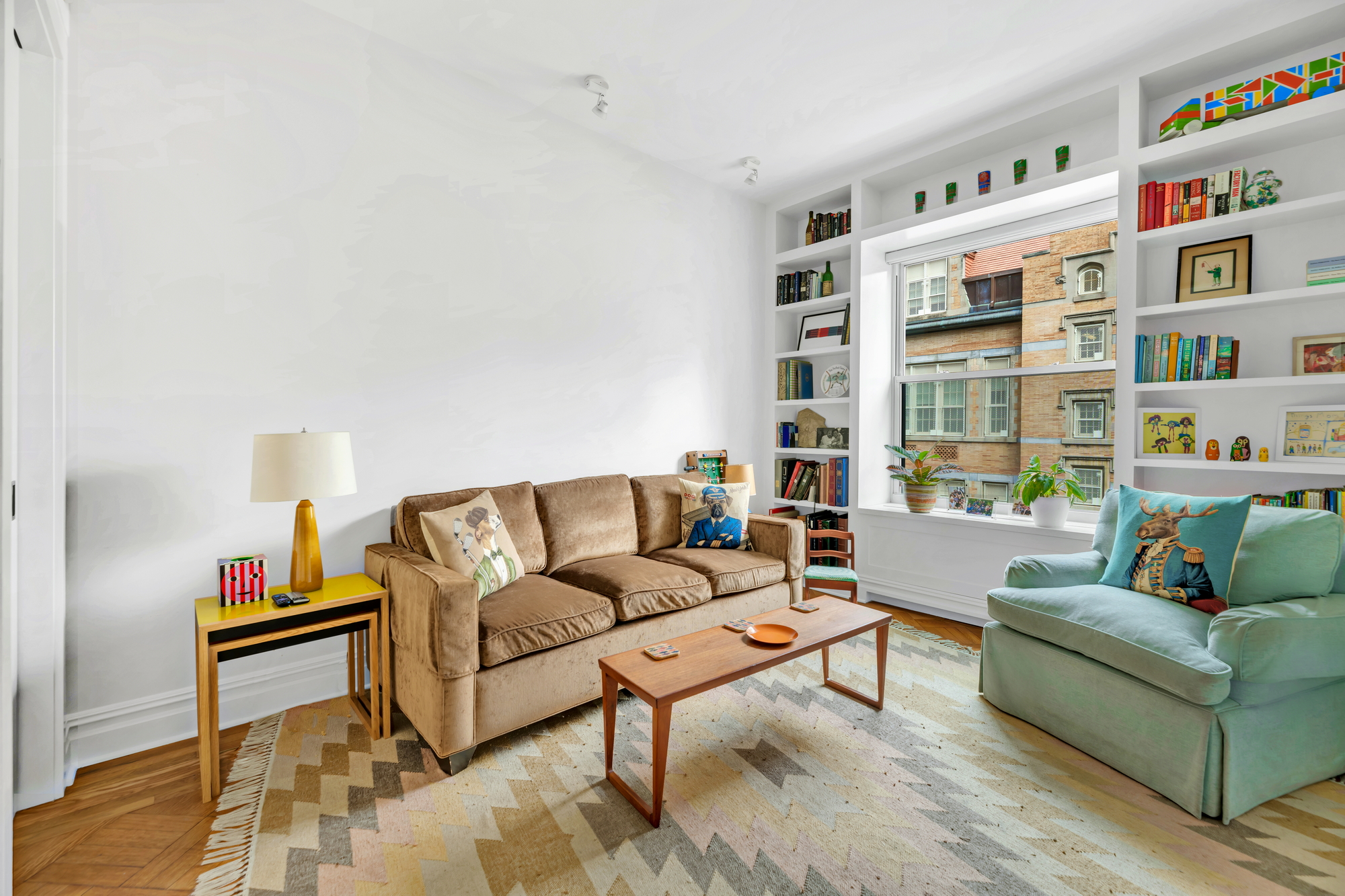 254 West 82nd Street, Unit 5A Manhattan, NY 10024 - Photo 10 of 18 a living room with furniture and a book shelf