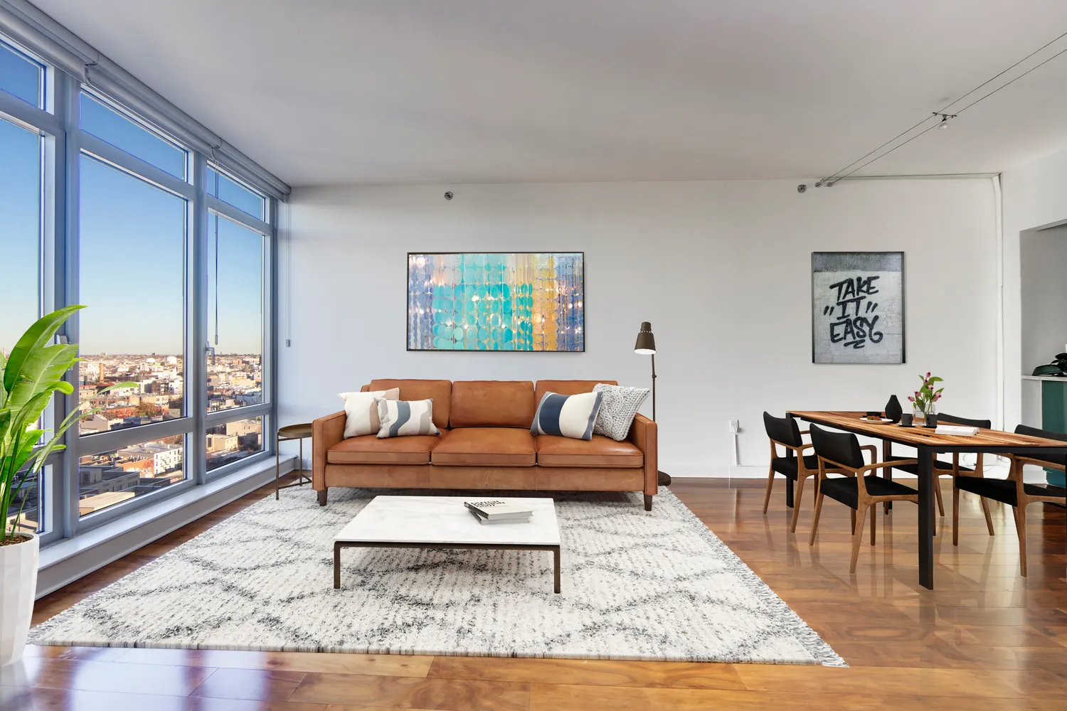 a living room with furniture wooden floor and a table